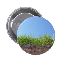 Dunkelgrünes Gras auf trockenem Boden Anstecknadelbuttons