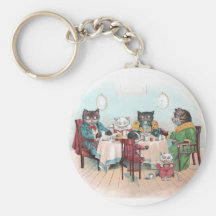 Katzen-Familie sitzt sich hin, um zu frühstücken Schlüsselbänder