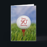 90. Geburtstags-Golfball Karte<br><div class="desc">Nah oben von einem weißen Golfball auf einem roten T-Stück im Gras mit Himmelhintergrund für 90. Geburtstag.</div>