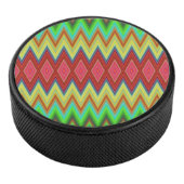 A circular speaker with a vibrant, zigzag pattern eishockey puck (3/4)
