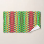 A colorful, geometric-patterned towel set hangs (Handtuch)