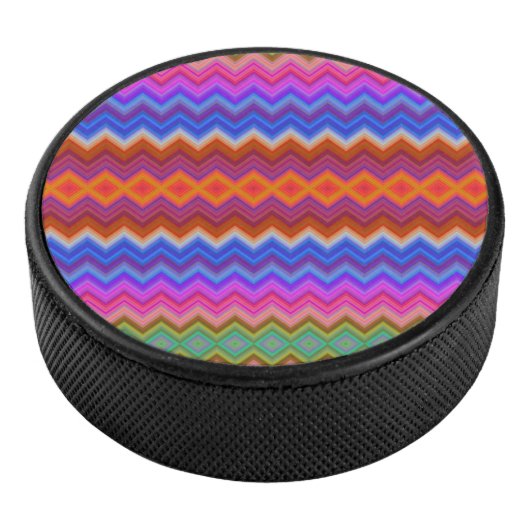 A colorful hockey puck features a vibrant zigzag (3/4)