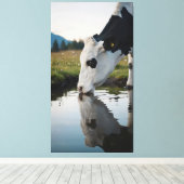 A cow drinks water in a natural stream leinwanddruck (Insitu (Holzboden))