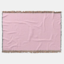 A decorative pink throw blanket with a subtle 