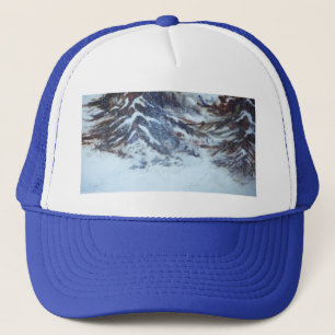 A heavy snow drift settles between two large pined truckerkappe