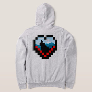 A lone figure sitting on a mountain peak at sunris hoodie
