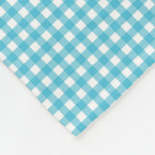 A patterned fabric with a blue and white gingham  fleecedecke (Ecke)