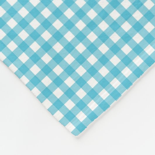 A patterned fabric with a blue and white gingham  fleecedecke (Ecke)