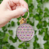 A round keychain features a detailed floral  schlüsselanhänger (Hand)