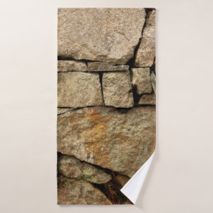 A stone wall made of cobblestones background textu badehandtuch
