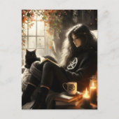 A witch reads with her black cat in a cozy chair postkarte (Vorderseite)