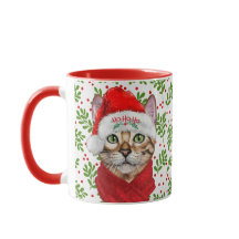 Abessinienkatze in einer Weihnachtsmannmütze mit H