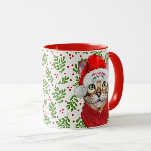Abessinienkatze in einer Weihnachtsmannmütze mit H Tasse (VorderseiteRechts)