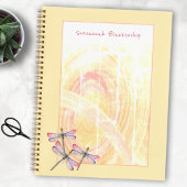 Abstrakte Dragonfische über Pastellfarben Notizblock