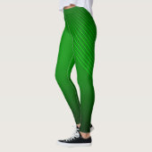 Abstrakte geometrische Linien auf tiefgrüner Ebene Leggings (Links)