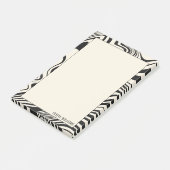 Abstraktes Muster hinter schwarzem Swirn Post-it Klebezettel (angewinkelt)