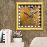 Adele Lady in Gold, Gustav Klimt Gerahmt, kariert Quadratische Wanduhr<br><div class="desc">Vintage Wall Clock mit dem berühmten Kunstwerk "Adele - die Dame in Gold" von Gustav Klimt gerahmt in goldenem Rahmen unterstrichen mit schwarz-weiß karierten karierten Stoffhintergrund.</div>