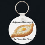 Adjarian Khachapuri  Schlüsselanhänger<br><div class="desc">Adjarian Khachapuri is a traditional Georgian dish from the region of Adjara, located along the Black Sea coast of Georgia. It is a boat-shaped bread made from soft yeast dough, filled with melted cheese, and topped with a fresh egg yolk and a slice of butter. Before eating, the egg and...</div>