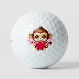 Adorable Baby Monkey hält ein rotes Herz Golfball