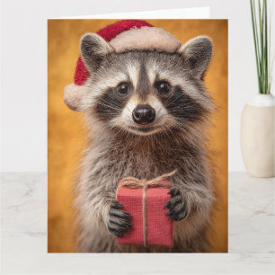 Adorable Raccoon in einer Weihnachtsmannmütze, die Karte