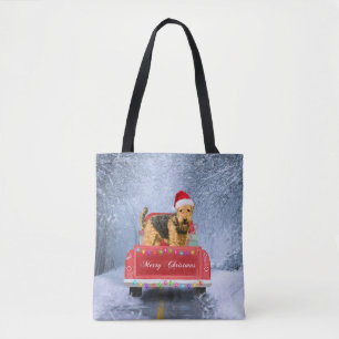 Airedale Terrier Dog in Snow sitzt zu Weihnachten Tasche