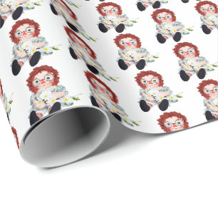 Alte Lumpenpuppe mit Gänseblümchenstrauß Geschenkpapier