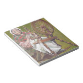 Ältere irische Frauenkraftlerin an einem Spinnrad Notizblock (angewinkelt)