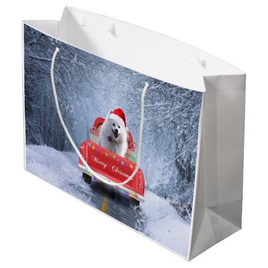 Amerikanischer Eskimo Hund im Schnee sitzen zu Wei Große Geschenktüte (Rückseite Schrägansicht)
