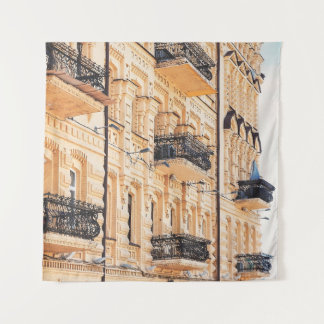 An old yellow house with wrought-iron balconies. f wandteppich