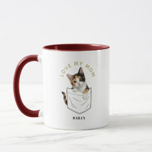Anbetungswürdige Dreifarbige Katze in der Tasche N Tasse