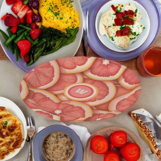 Anfänglich frisch gepicktes rosa Grapefruitmonogra Pappteller