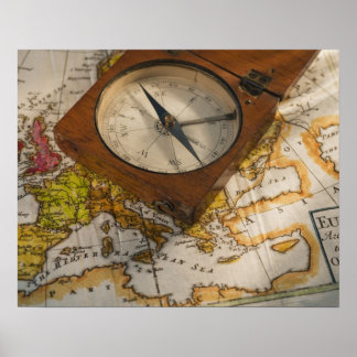 Antique compass on map poster