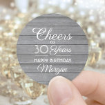 ANY Birthday Cheers Rustic Wood Vintage Gray White Runder Aufkleber<br><div class="desc">Add a personalized finishing touch to birthday party invitations and favors with these stylish faux grey wood round stickers / envelope seals. Design features modern script calligraphy editable "Cheers to 30 Years" on a rustic gray wood look background. This template is set up for a 30th birthday celebration, but is...</div>