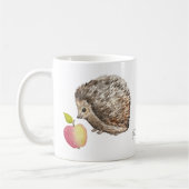 Aquarellfarbener niedlicher Igel und Apfel Kaffeetasse (Links)