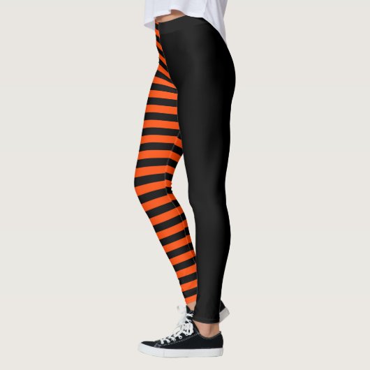 Asymmetrisches Schwarz und Orange Streifen Leggings (Links)