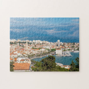 Aufgeteilte Stadt am Meer aus der Vogelperspektive Puzzle