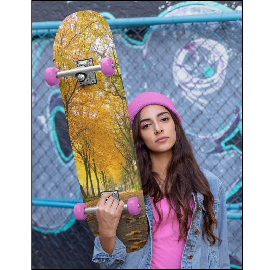 Autumn path with yellow trees and fallen leaves skateboard