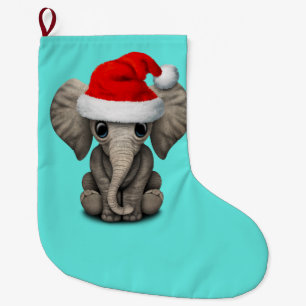 Baby-Elefant, der eine Weihnachtsmannmütze trägt Großer Weihnachtsstrumpf