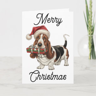 Basset Hound in Weihnachtsmannmütze im Mund Karte