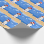 Beagle Hund sitzend am Weihnachtshut am Strand Geschenkpapier (Ecke)