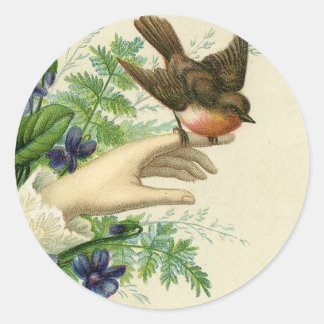 Beautiful hand with a bird and flowers runder aufkleber