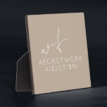 Beige WiFi Password signieren Easel Stand Fotoplatte<br><div class="desc">Behalt deine Gäste mit dieser stilvollen und funktionalen WiFi-Passwort-Schild-Plakette verbunden. Das elegante beige Design mit einem zarten Script-Schriftart macht es zu einer perfekten Ergänzung zu jeder Zuhause- oder Büroeinrichtung. Die 5, 25x5, 25-Plakette ist mit einem bequemen Ständer für eine einfache Darstellung ausgestattet. Schreiben Sie einfach Ihr WiFi-Passwort auf das Schild...</div>