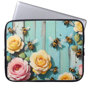 Belebte Bienen mit rosa und gelben Rosen auf alter Laptopschutzhülle