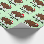 Bison in einer Weihnachtsmannmütze am Geschenkpapier (Ecke)