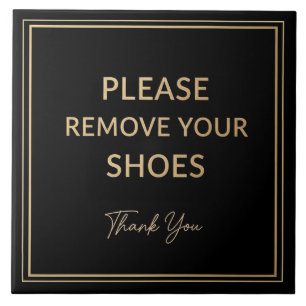 Bitte entfernen Sie Ihre Schuhe Schild schwarz und Fliese