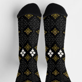 Black socks featuring a gold and white pattern  socken