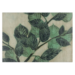 Blätter und Niederlassungen auf Sahnehintergrund Schneidebrett