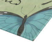 Blau-Winged Schmetterling auf aquamariner Schneidebrett (Ecke)