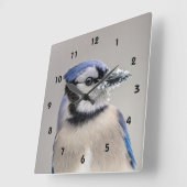 Blaue Jay mit Schnee auf seinem Schnabel Quadratische Wanduhr (Winkel)