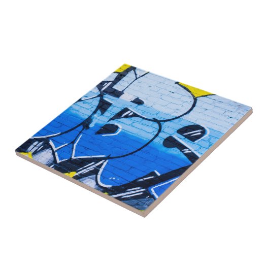 Blaugraffiti an einer Ziegelwand Fliese (Seite)